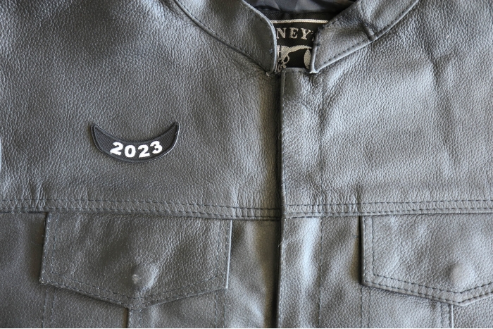 2023 Year Patch Lower Rocker White - 2.5x1 inch - Embroidered Iron on Patch shown on leather vest