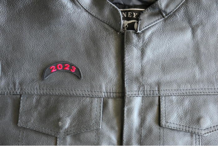 2023 Year Patch Upper Rocker Red - 2.5x1 inch - Embroidered Iron on Patch shown on leather vest