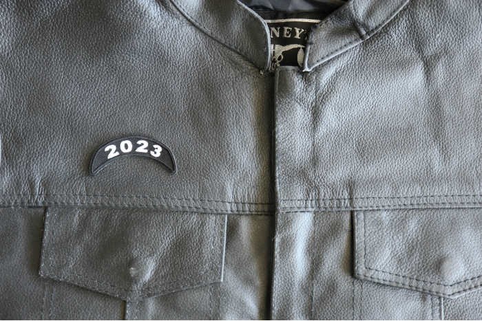 2023 Year Patch Upper Rocker White - 2.5x1 inch - Embroidered Iron on Patch shown on leather vest