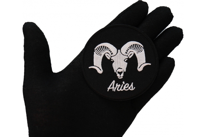 Aries zodiac sign shown on hand for size comparison