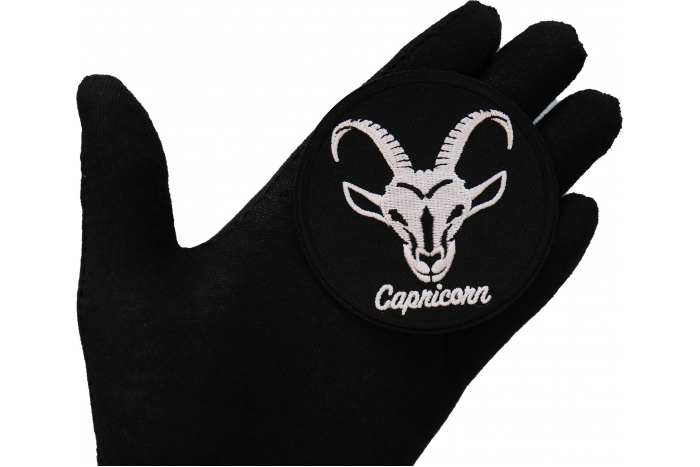 Capricorn zodiac sign shown on hand for size comparison