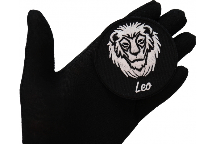 Leo zodiac sign shown on hand for size comparison
