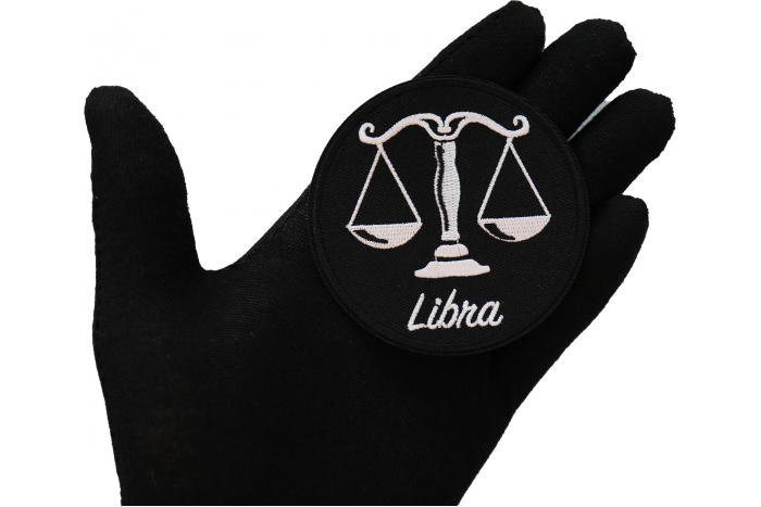 Libra zodiac sign shown on hand for size comparison
