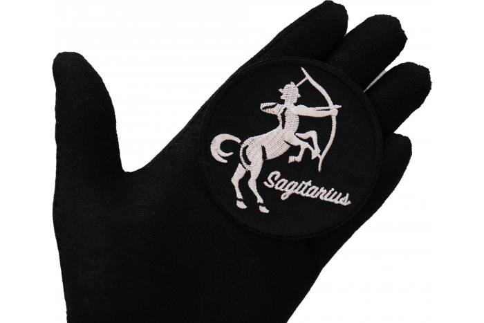 Sagitarius zodiac sign shown on hand for size comparison