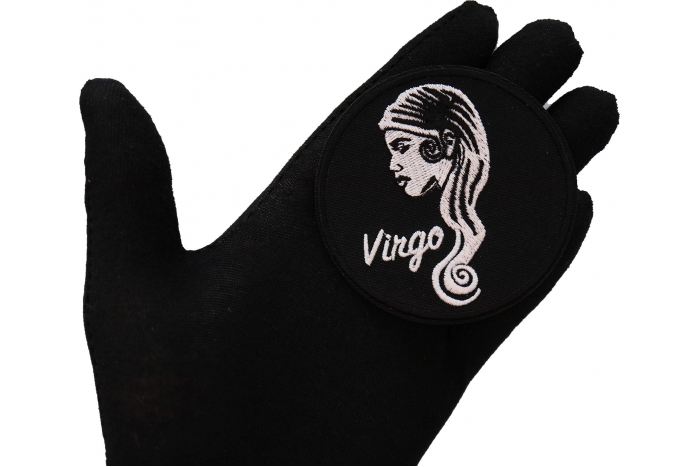Virgo zodiac sign shown on hand for size comparison